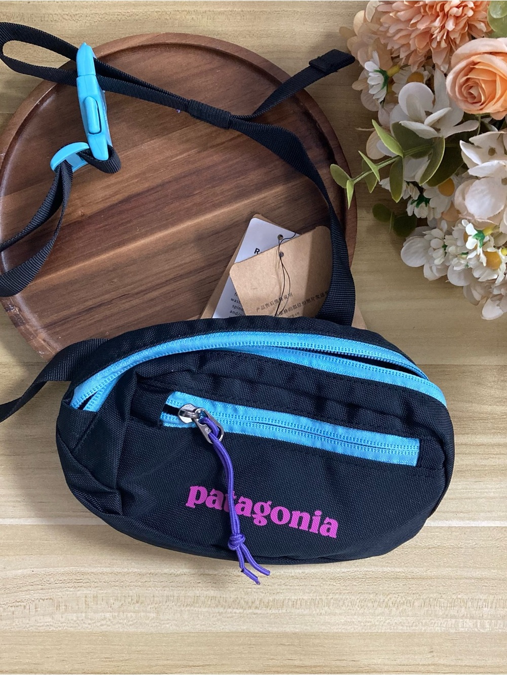 Patagonia Black Crossbody Waist Pack with Blue Zippers and Pink Logo